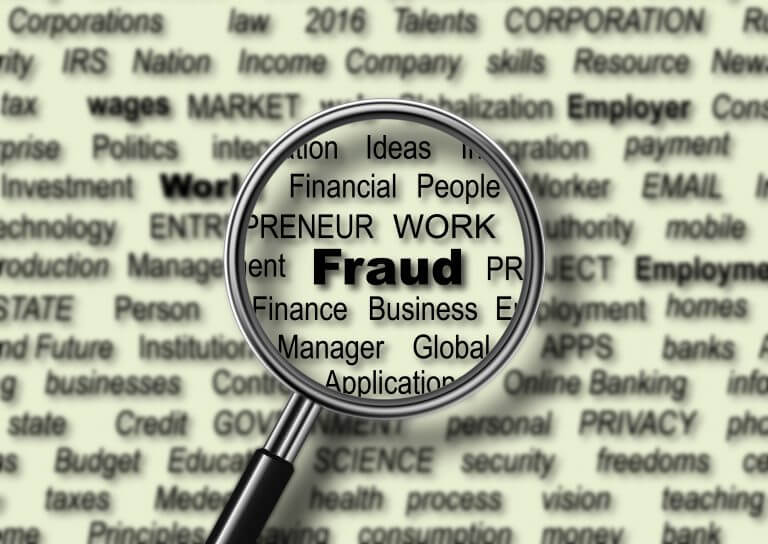 magnifying glass over the word fraud