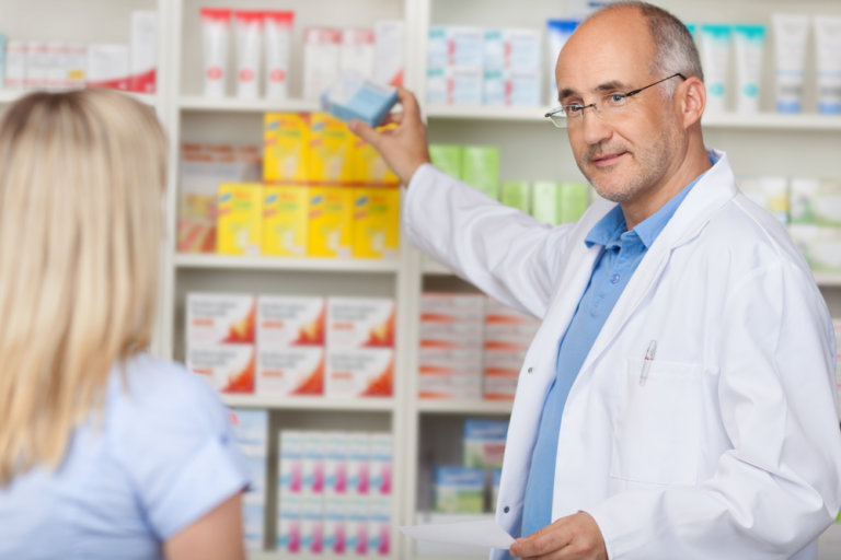 pharmacist reaching for meds
